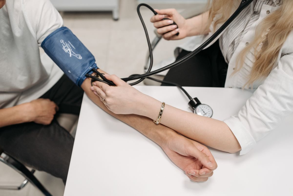 A doctor checking a man's blood pressure